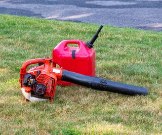 Leaf blower and petrol can on a lawn